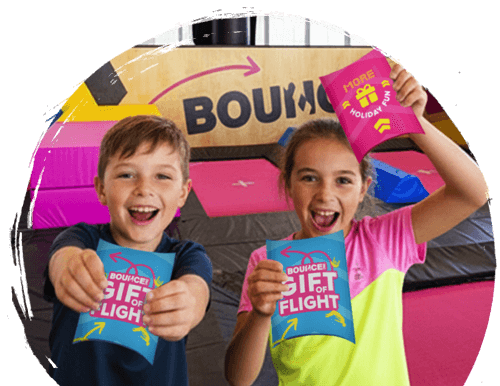 Kids holding gift of flight pack at bounce